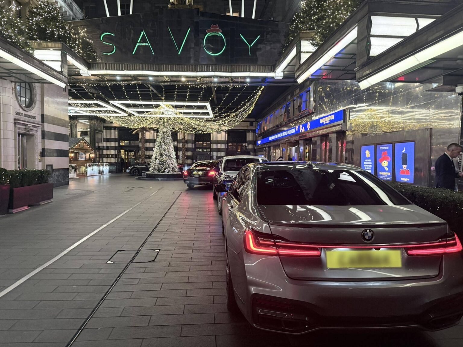 BMW 7 Series chauffeur car at the entrance of The Savoy in London at night