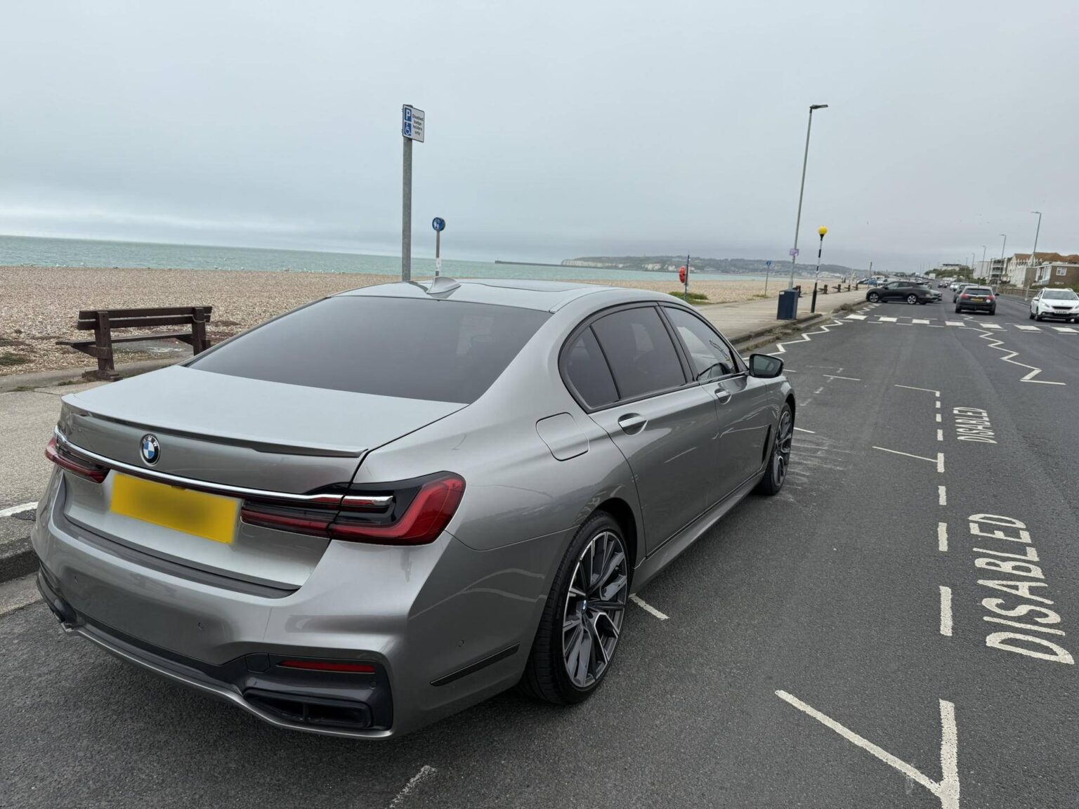 BMW 7 Series chauffeur car parked on the seafront by the beach