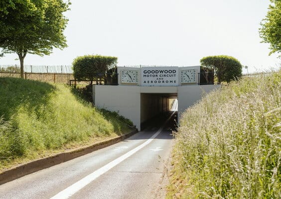 Elegant entrance to Goodwood, highlighting luxury chauffeur services for sporting events