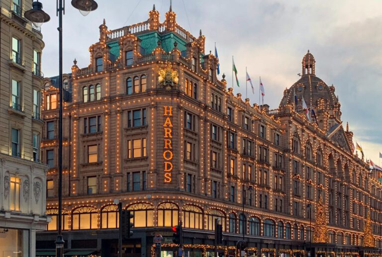 Harrods in Knightsbridge, London, lit up at dusk